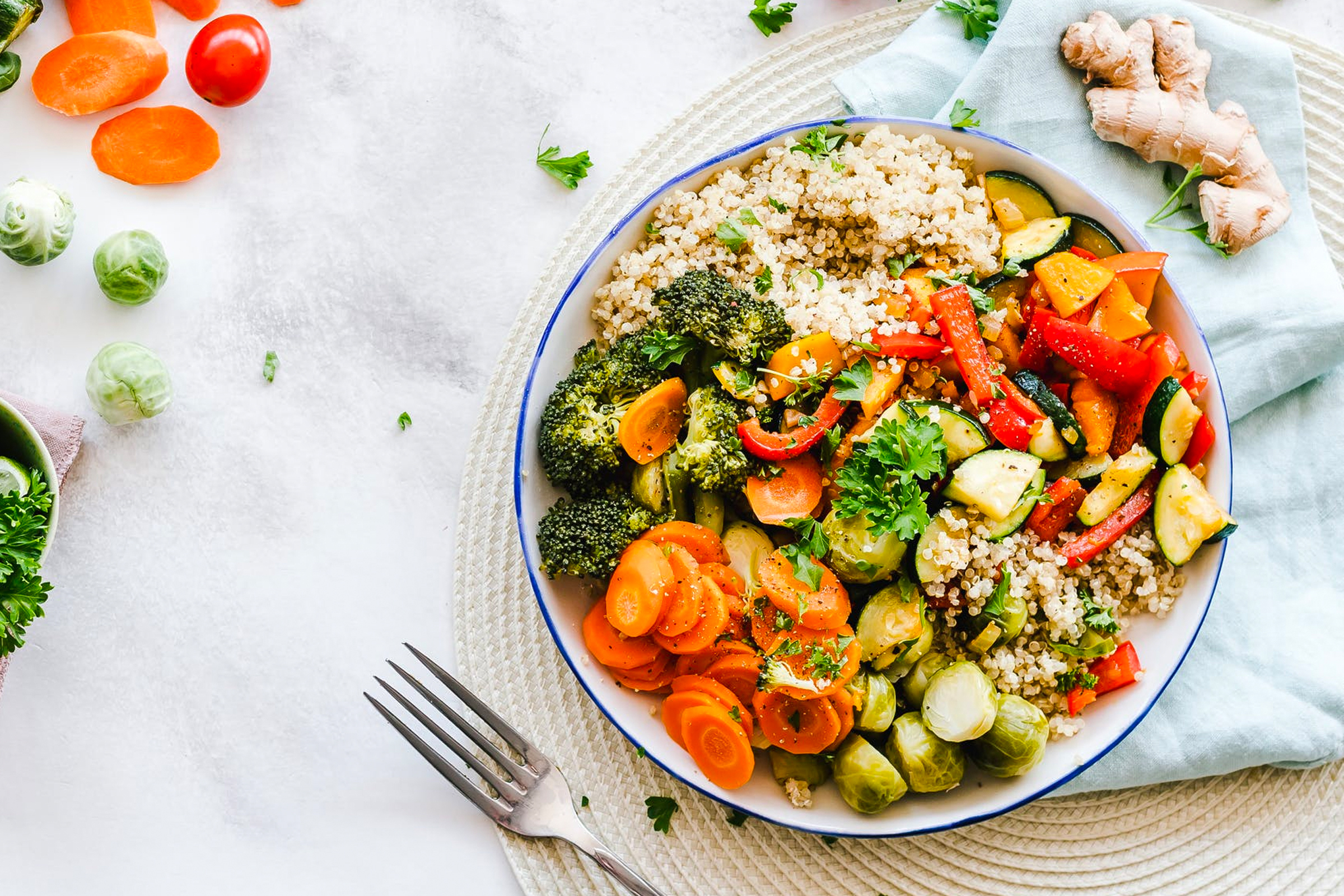 Color vegetable and quinoa salad on marble table